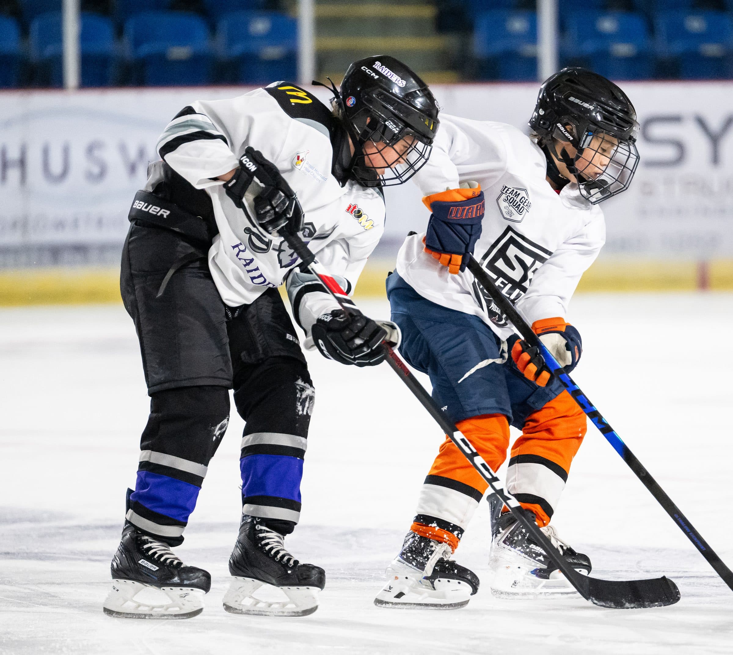 Two young players working on puck control in a skills drill